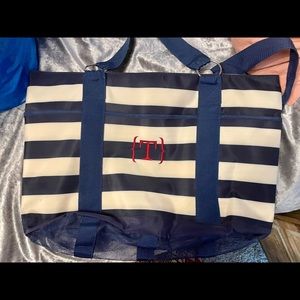 Extra large vinyl bag with mesh bottom. Initial “T” on bag. Navy stripe